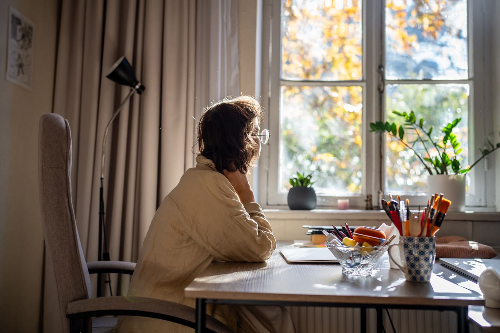 Person working at a sunlit desk at home