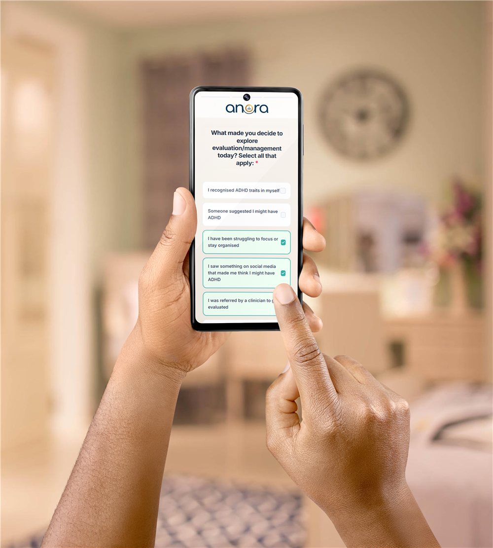 Hands holding a phone showing the Anora intake questionnaire